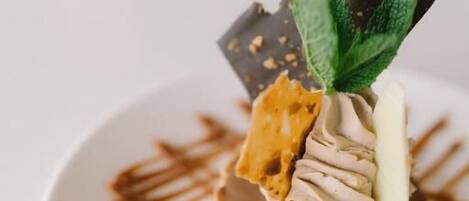 A dessert on a white plate with caramel drizzle.