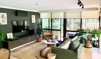 Deluxe Apartment, 2 Bedrooms, Garden View, Garden Area | Living area | 30-inch flat-screen TV with cable channels, books