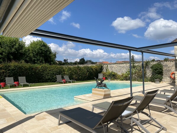 Seasonal outdoor pool, open 8:00 AM to 8:00 PM, pool loungers