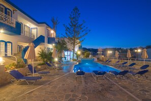 Outdoor pool, open 9:00 AM to 6:00 PM, pool loungers