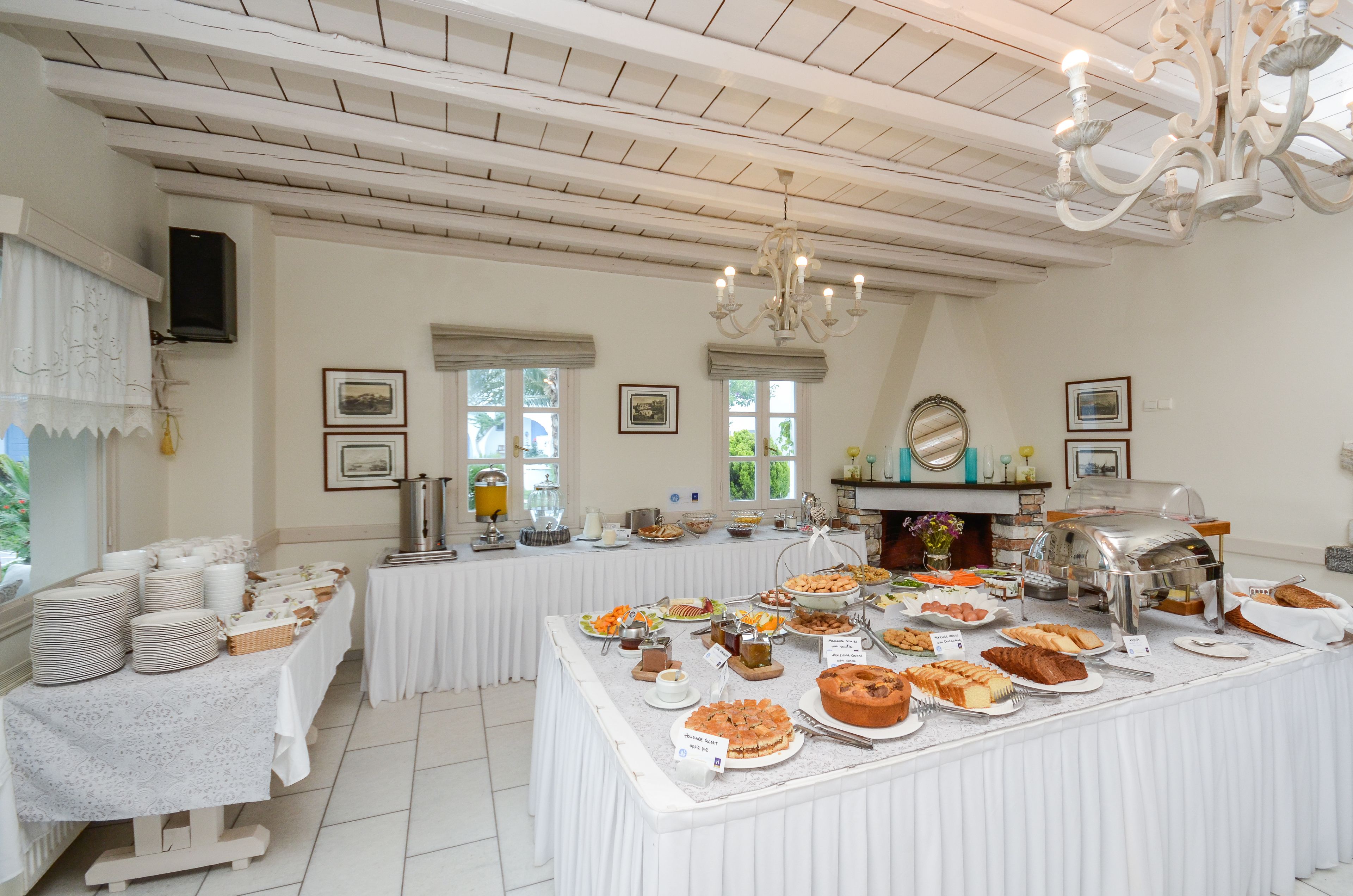 A buffet setup with various food items and a coffee station.