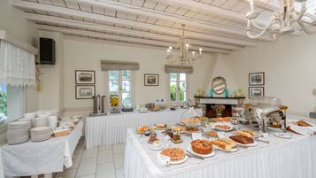 A buffet setup with various food items and a coffee station.
