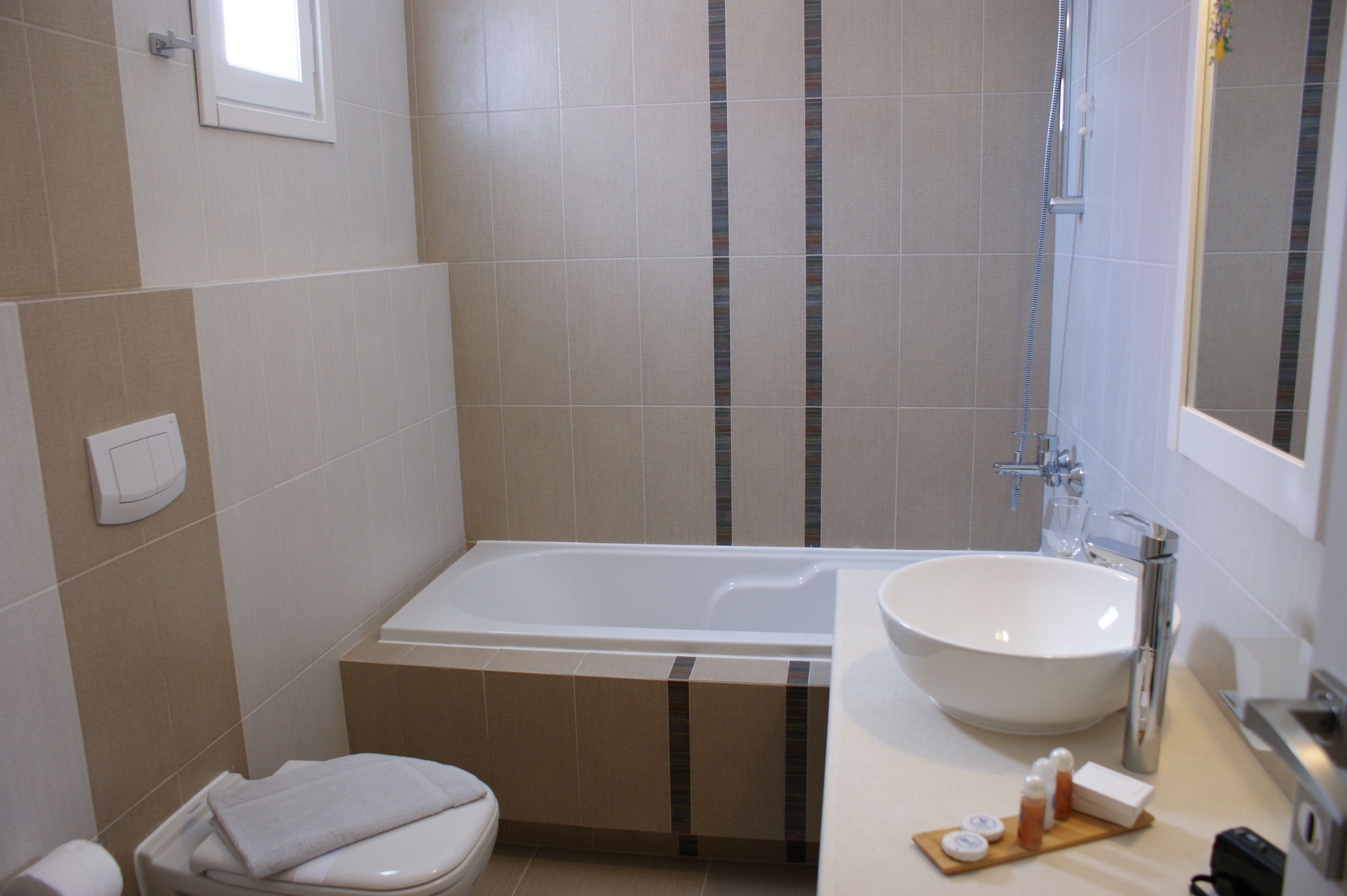 Un baño con bañera, lavabo e inodoro.
