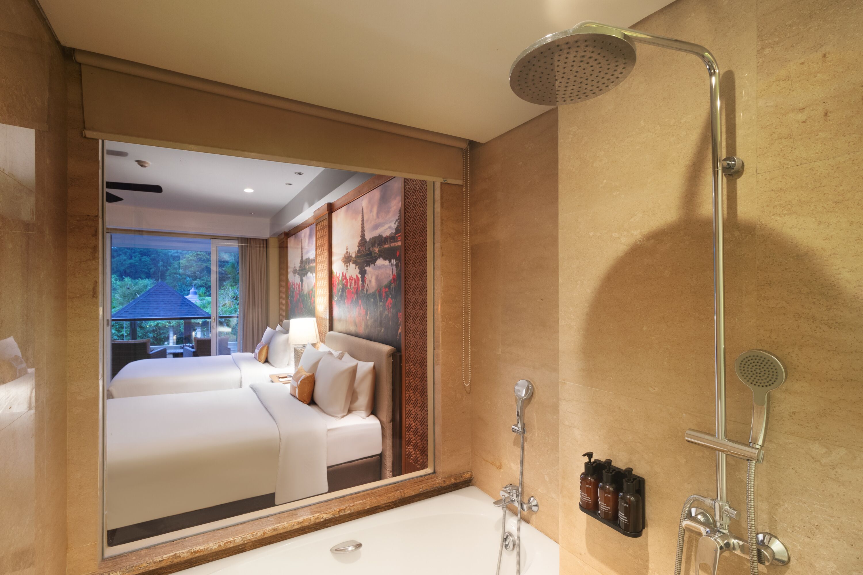 A hotel room with a large mirror, a bathtub, a shower, and a view of a garden.