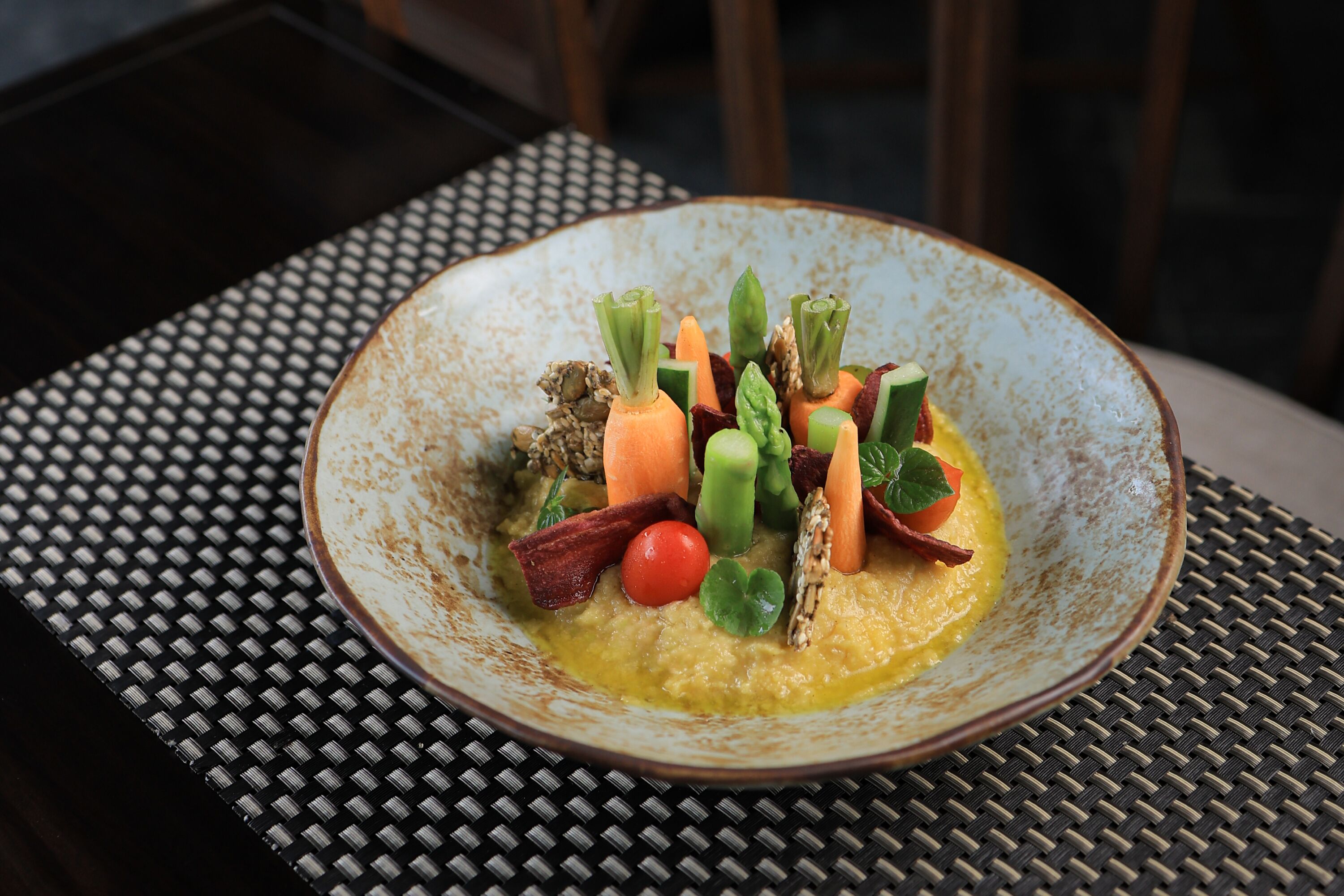 A plate of food on a table with a woven placemat.