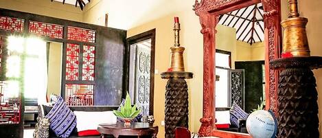 A traditional room with a sofa, a table, and a globe.