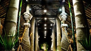 A temple interior with stone statues, columns, and a central altar. - Hotel Tugu Lombok (Tanjung)