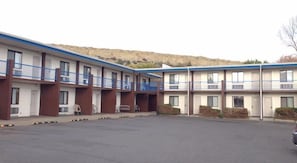 Guest rooms offer balconies with views of the surrounding hill.