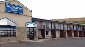 Simple, functional design with a prominent sign and flat roof.