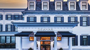 A two-story building with a classic architectural style, featuring a prominent entrance with a black door and a sign above that reads "DEIAMAR SOUTHPORT". - Delamar Southport (Southport)