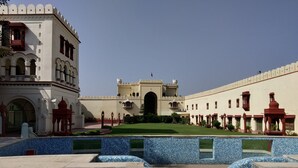 A courtyard with a pool, a large building with arches, and a central gate. - The Fort Ramgarh (Panchkula)