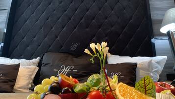 A table with a charcuterie board featuring various meats, cheeses, fruits, and vegetables.