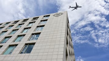 Located near the airport, this high-rise building features a unique geometric pattern on its facade.