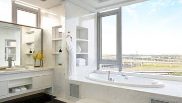 A modern bathroom with a large window, a bathtub, and a vanity with a mirror.