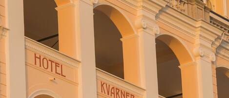 A building with three arched windows labeled "HOTEL," "KVARNER," and "PALACE."