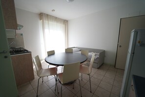 Standard Apartment, 1 Bedroom | Living area | 26-inch TV with digital channels - Residence Lugano (Rimini)