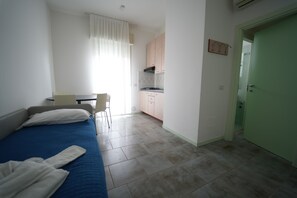 Apartamento estándar, 1 habitación | Zona de estar | Televisión de 26 pulgadas con canales digitales