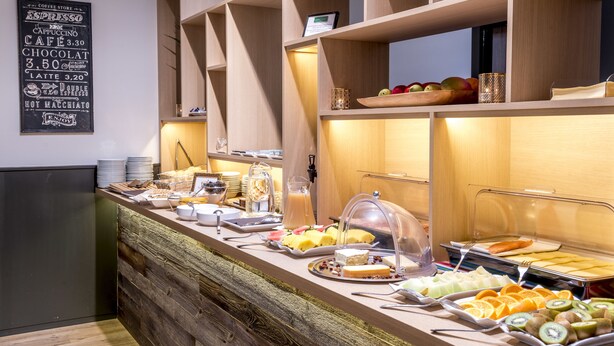 A buffet setup with various food items and a menu board. - Hotel Albert Plage (Knokke-Heist)