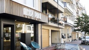 A hotel with a modern facade, a red vintage car parked in front, and a sign indicating the hotel's name. - Hotel Albert Plage (Knokke-Heist)
