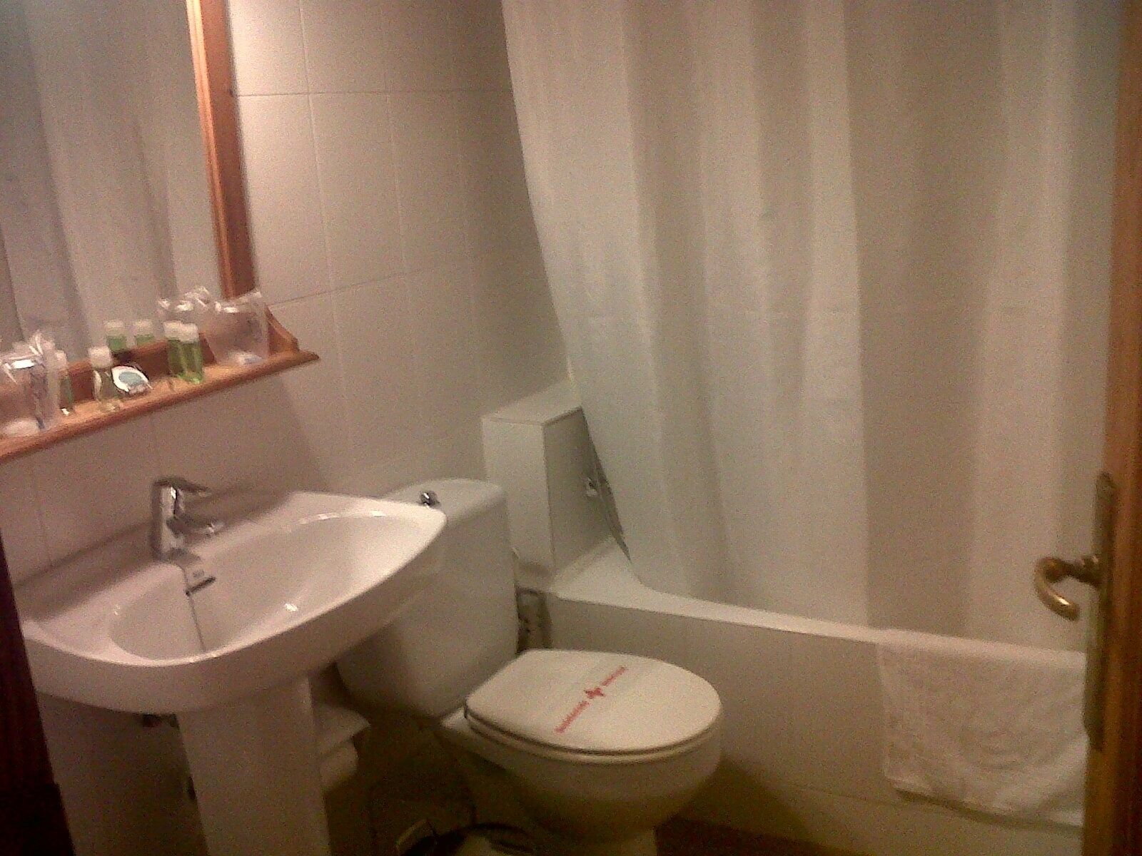 A bathroom with a sink, toilet, and bathtub.