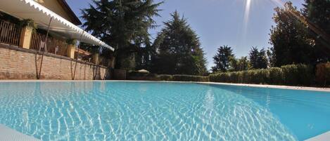 Seasonal outdoor pool, open 10:00 AM to 7:00 PM, pool loungers