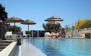 Seasonal outdoor pool, open 8:00 AM to 7:00 PM, pool umbrellas