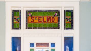 A stained glass window with the word "STELMO" and decorative elements.