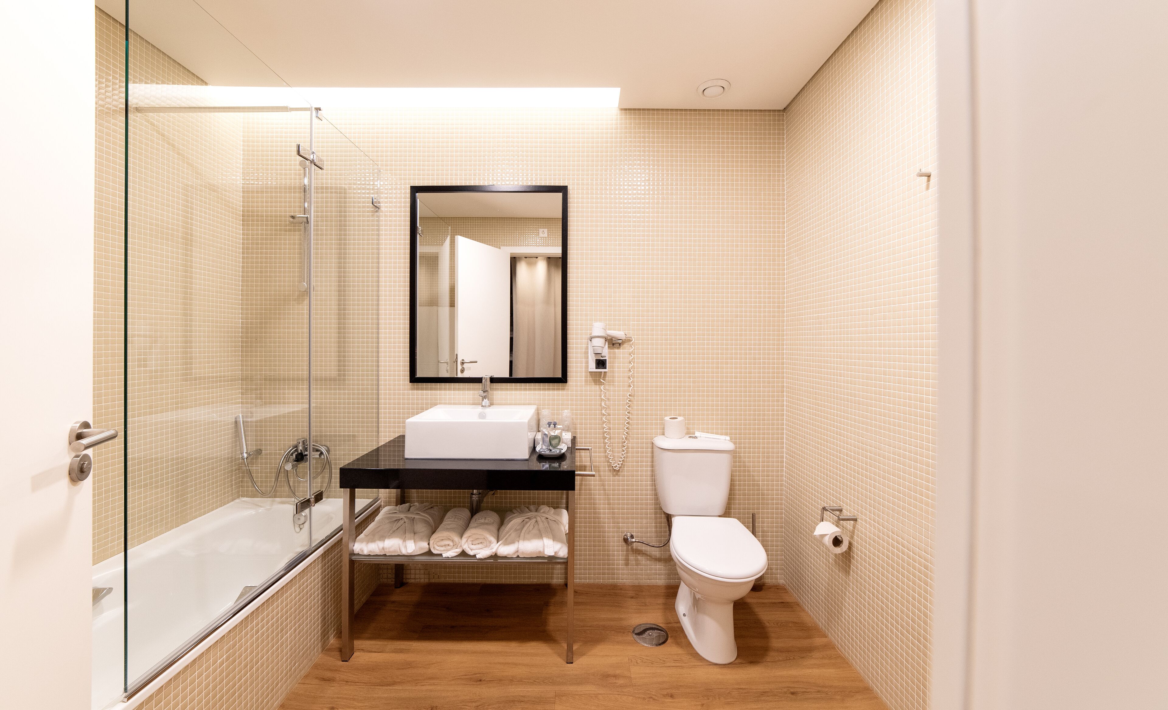 junior suite, mountain view | bathroom | combined shower/bathtub, rainfall showerhead, designer toiletries