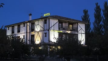 A two-story building with a balcony and a sign that reads "HOTEL".