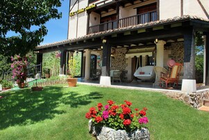 A two-story building with a covered patio area.