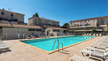 Seasonal outdoor pool, open 10:00 AM to 7:00 PM, pool loungers