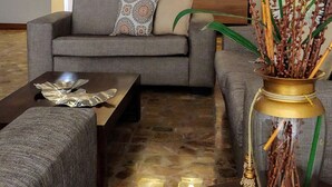 Un moderno vestíbulo de hotel con un sofá, una mesita de centro y un jarrón decorativo.