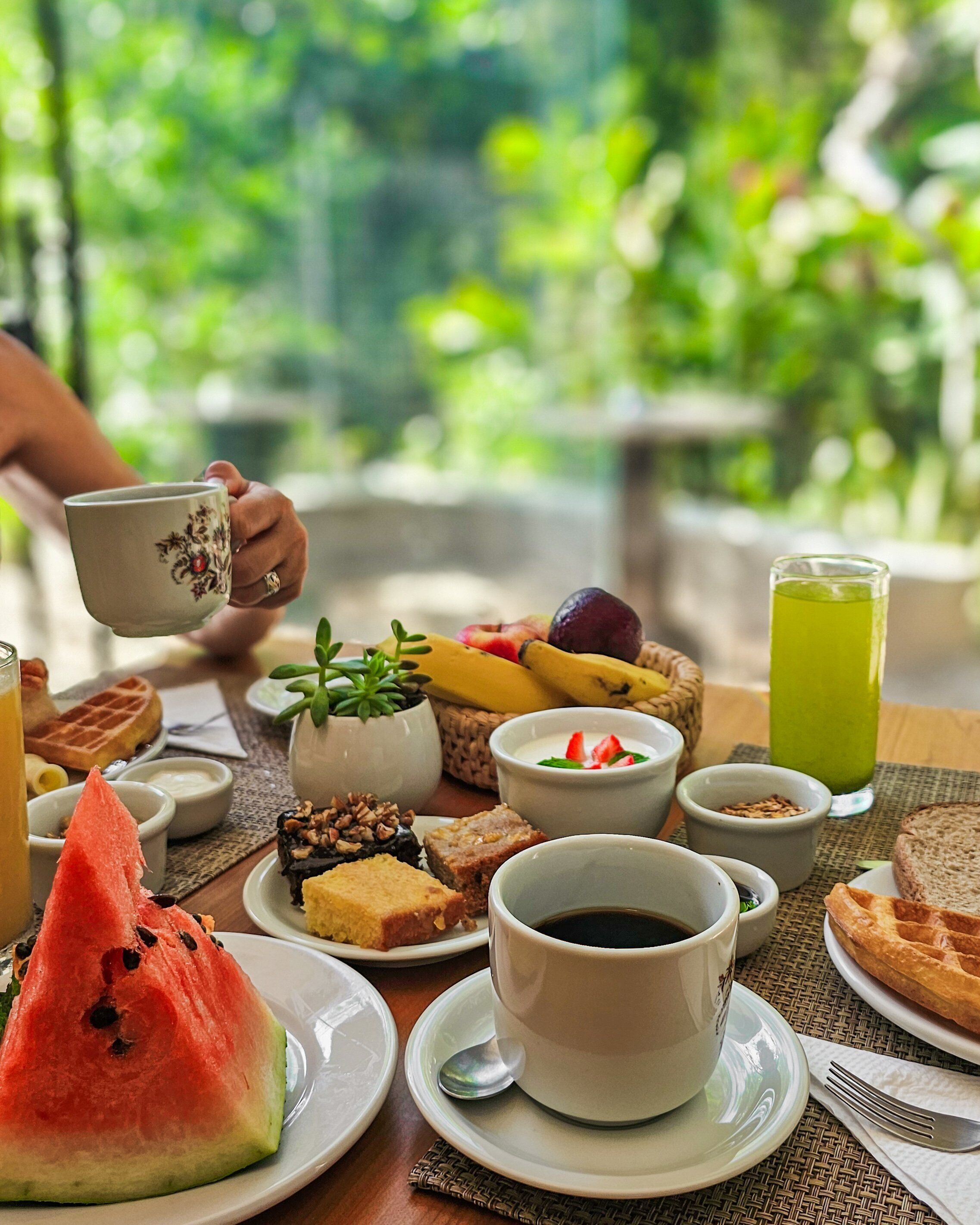 Una mesa con diversas opciones de comida y bebida para el desayuno.