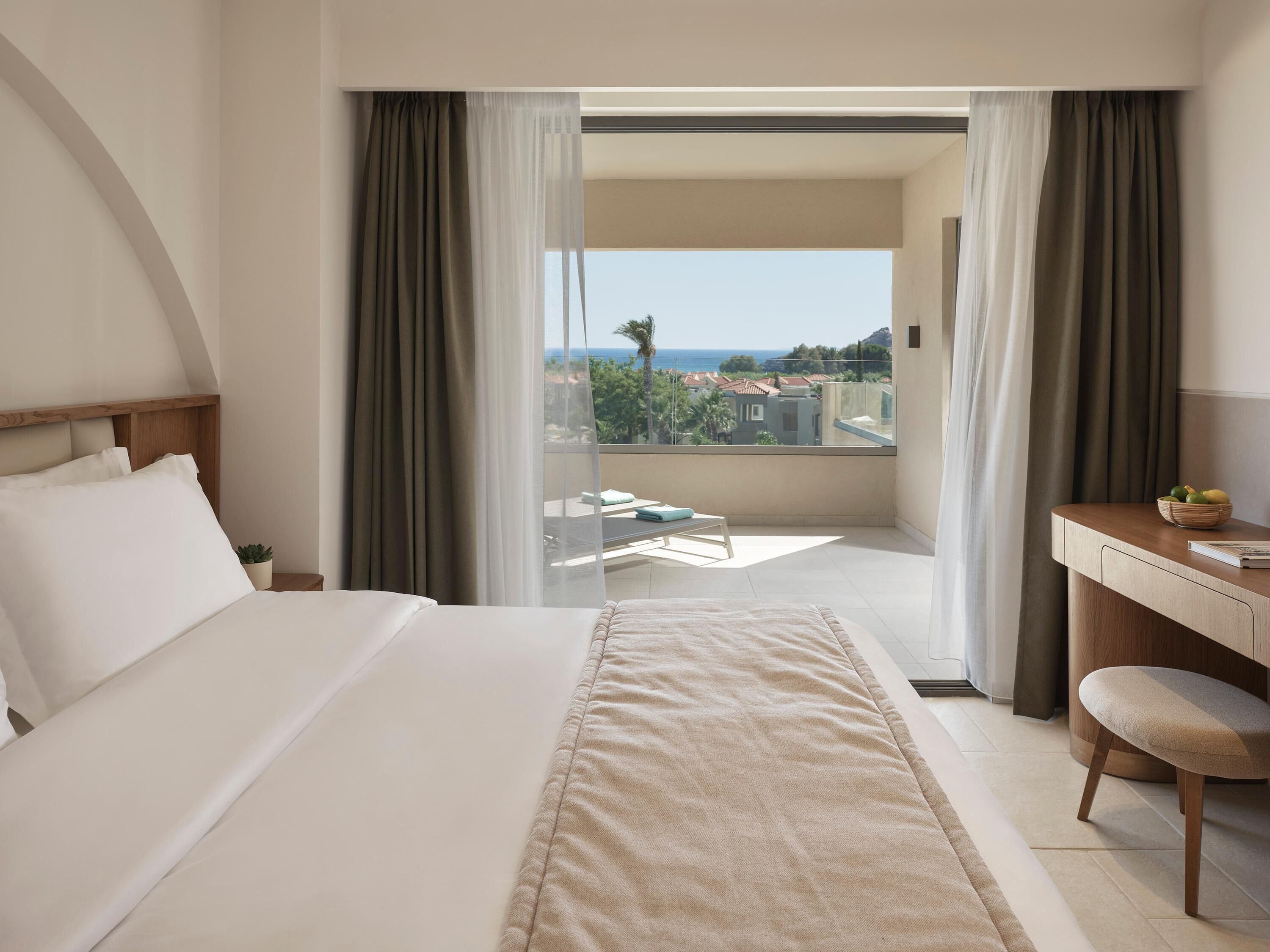 Executive Suite, Sea View | Free minibar, in-room safe, desk, blackout drapes