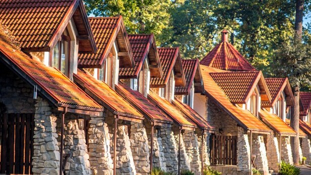 A row of stone buildings with pitched roofs and wooden accents. - Park Hotel Drevny Grad (Lviv)