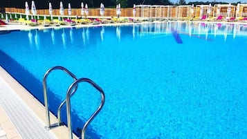 3 outdoor pools, open 8 AM to 8 PM, pool umbrellas, pool loungers