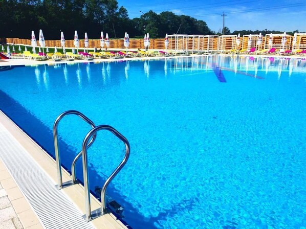 3 outdoor pools, open 8 AM to 8 PM, pool umbrellas, pool loungers