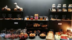 A breakfast buffet with various food items and condiments.