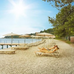 On the beach, white sand, sun-loungers, beach umbrellas