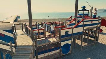 On the beach, white sand, sun loungers, beach umbrellas