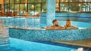 A swimming pool with tiled edges and a clear view of the surrounding area.