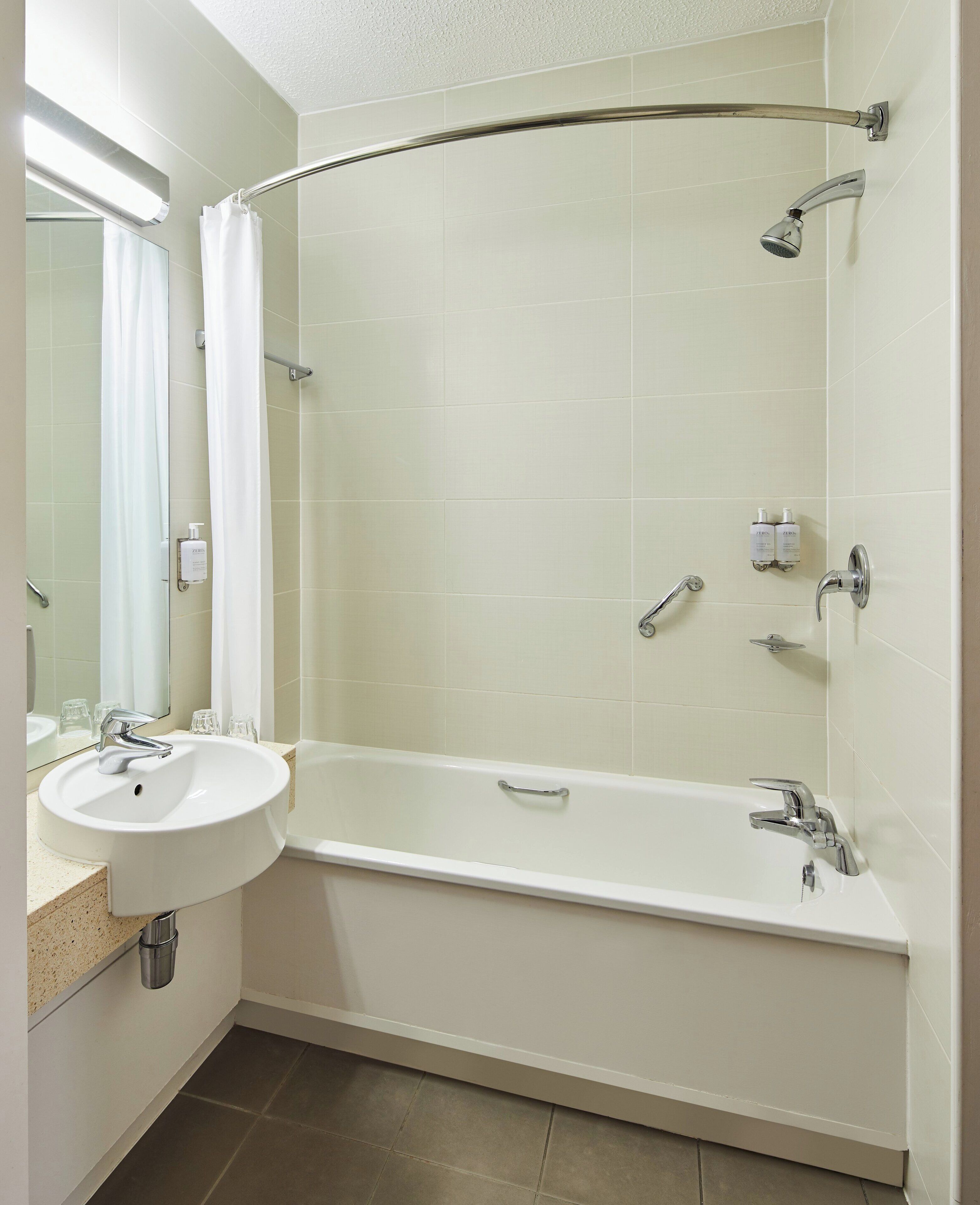 combined shower/bathtub, designer toiletries, hair dryer, towels