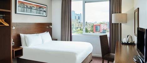 Hypo-allergenic bedding, desk, laptop workspace, blackout curtains