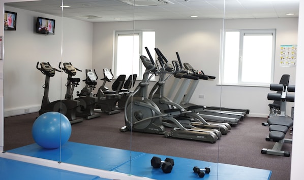 A gym with treadmills, exercise balls, and dumbbells. - Leonardo Hotel Bradford (Bradford)