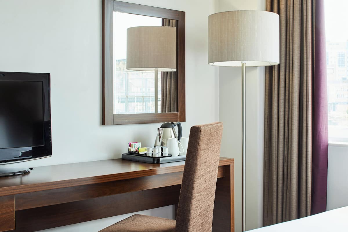 hypo-allergenic bedding, desk, laptop workspace, blackout curtains