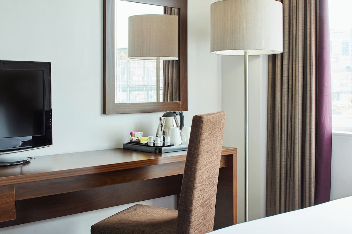 Hypo-allergenic bedding, desk, laptop workspace, blackout curtains