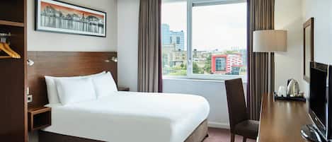 Hypo-allergenic bedding, desk, laptop workspace, blackout drapes