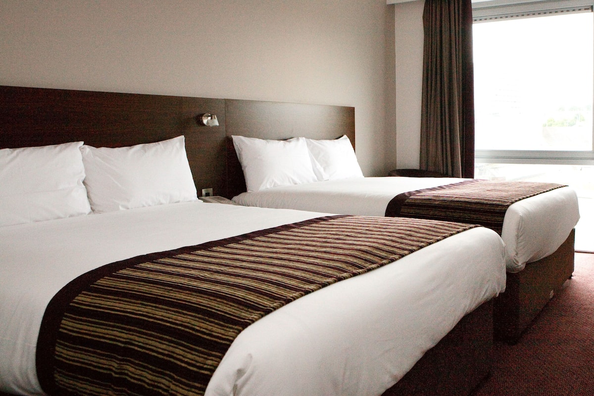 Hypo-allergenic bedding, desk, laptop workspace, blackout curtains