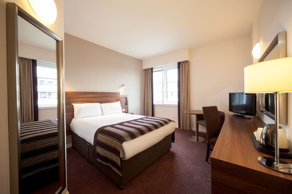 Hypo-allergenic bedding, desk, laptop workspace, blackout curtains