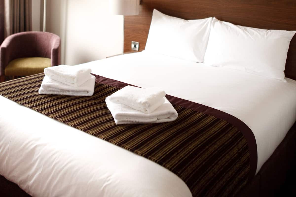 Hypo-allergenic bedding, desk, laptop workspace, blackout curtains